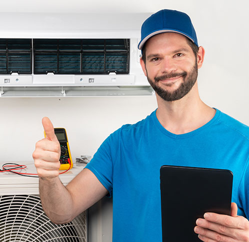 Technician giving thumbs up next to energy efficient AC unit